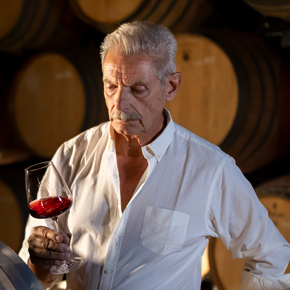 Wine consultant, Carlo Ferrini, inspecting wine in a glass